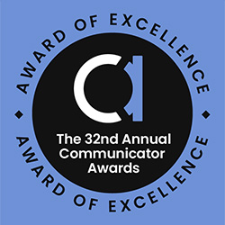 A circular badge with a black center and blue border reads The 32nd Annual Communicator Awards in the middle and Award of Excellence around the edge. A stylized C and A graphic is also featured.